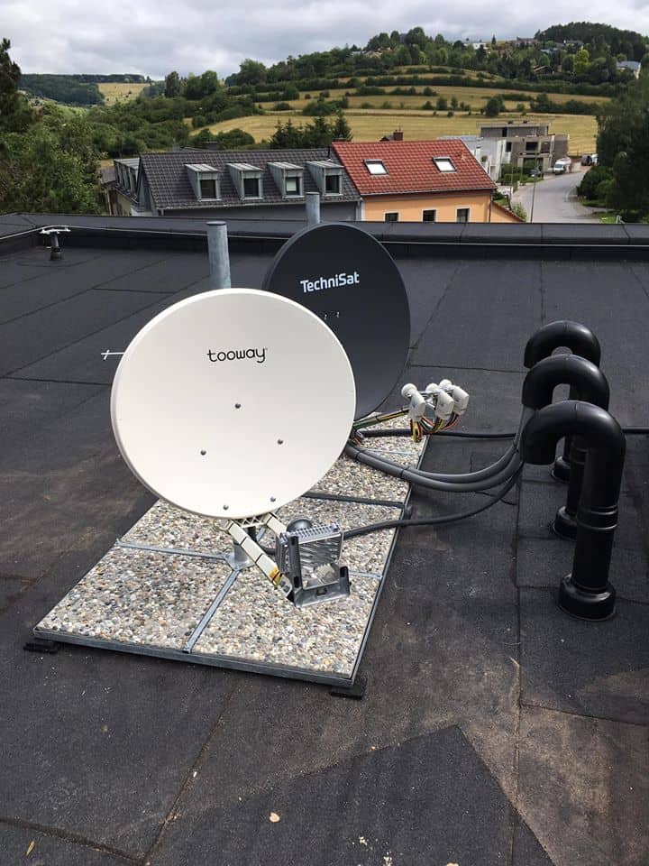 Twin satellite dishes on a flat roof